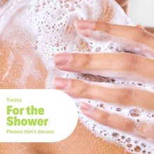 Hands lathering with creamy body wash bubbles