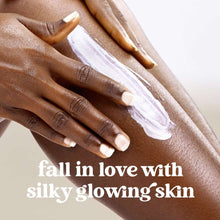 Creamy white body scrub on hands, 'silky glowing skin' text