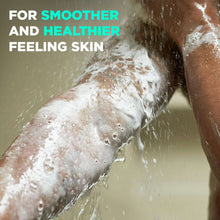 Foamy body wash suds on skin during shower, water splashing around arm