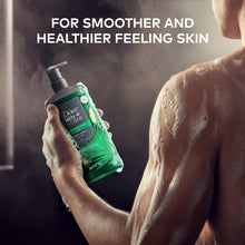 Dove Men+Care coastal cedar body wash bottle with pump in hand