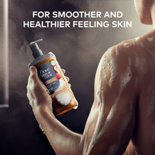 Dove Men Care body wash bottle with pump held in hand with lather.
