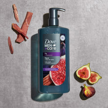 Moisturizing body wash bottle with pump, dark blue bottle near fig fruit and wood pieces.
