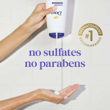 Body wash dispensed onto hands from a white bottle with purple pump.