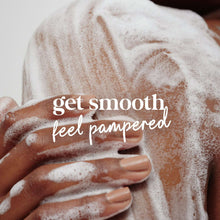 Hands covered in creamy body wash foam with soft lather texture