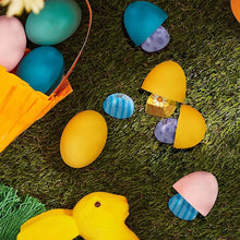 Assorted Easter chocolate candies among green grass with colored foil eggs