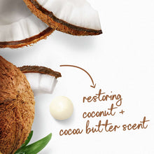 Dove body wash ingredients with coconut halves, cocoa butter piece, and green leaves