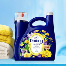 Limited edition liquid fabric softener bottles, navy blue with Bloom floral label