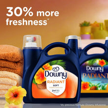 Downy Radiant liquid fabric softener bottle with folded towels