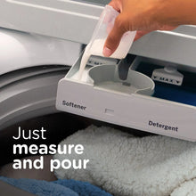 Downy Soft Free & Gentle liquid fabric softener being poured into washer softener cup