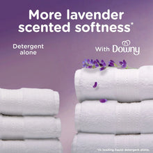 Folded white towels with lavender scented softness and Downy comparison graphic