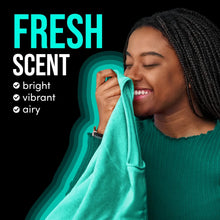 Fresh scent laundry towel being held by a person, teal towel close-up