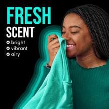Smiling woman holding a teal laundry towel with fresh scent callout