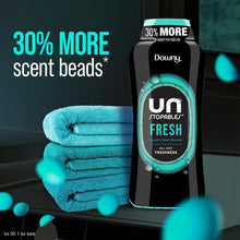 Downy Unstopables Fresh laundry scent booster beads bottle beside folded towels