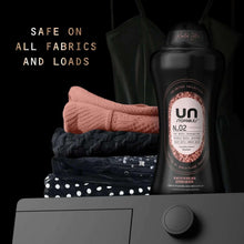 Laundry scent booster bottle with stacked towels, safe on all fabrics text