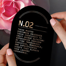 N.02 scent booster description card held up by fingers