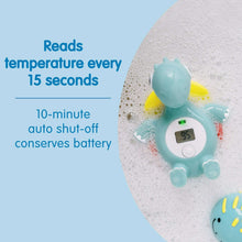 Teal dinosaur floating bath thermometer floating in bubbles with LCD temperature display.