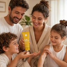 Family smiling while one person holds Dr. Botanicals Lemon body butter