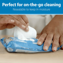 Resealable baby wipes pouch opened with white wipes being pulled out by hands.