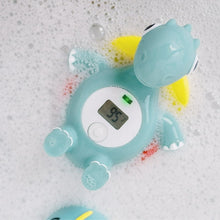 Floating green dinosaur bath thermometer with digital screen and temperature light