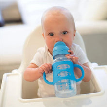 Blue sippy straw bottle with silicone handles on tray, baby using