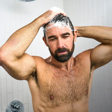 Man applying moisturizing conditioner to wet hair