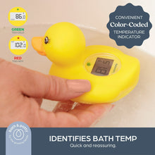 Yellow duck bath thermometer held in hand with LCD display