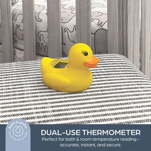 Yellow duck digital thermometer on striped fabric surface