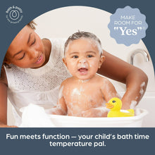 Yellow duck bath thermometer floating in baby bath water