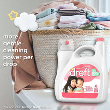 Baby liquid laundry detergent bottle with pink label, standing near folded baby clothes