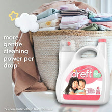 Baby liquid laundry detergent bottle next to folded baby clothes in a basket