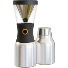 Countertop coffee grinder with black base, orange ring, and stainless canisters