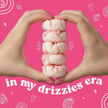 Heart-shaped stack of frosted strawberry mini rice cakes in both hands
