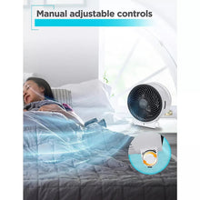 Desktop heater and fan with manual control knob and black grille, side angle.