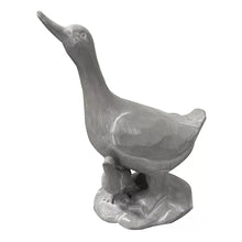 Duck statue, dark gray, raised wing and beak, perched on sculpted base