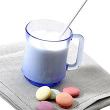 Blue glass stackable mug with spoon and creamy beverage