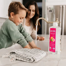 Liquid dish soap bottle with grapefruit label and pump dispenser