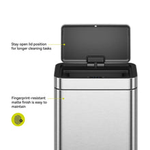 Matte stainless steel motion sensor trash can with lid held open for cleaning tasks