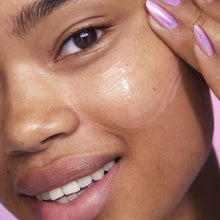 Face close-up with dewy serum sheen on cheeks and forehead