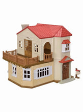 Dollhouse playset with cream walls and red shingled roof, front veranda and doors