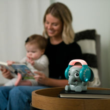 Elephant Bluetooth sound soother on a table as a parent and baby sit nearby