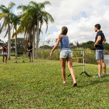 Outdoor ladderball game with freestanding frame and players holding thrower beanbags
