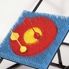 Close-up of blue woven lawn darts target board with red bullseye
