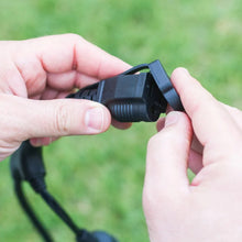 Black cafe string light connector being plugged into the outdoor power cord