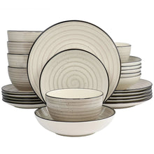 Stoneware dinnerware set in cream: stacked plates and speckled bowls with swirl rims