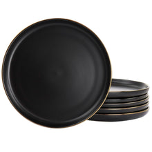 Matt black stoneware dinner plate set with thin gold rim, stacked view