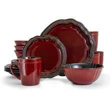 Red stoneware dinnerware set with scalloped plates, bowls, and mugs