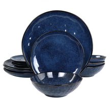 Blue stoneware dinnerware set: stack of dinner plates and bowls with speckled finish
