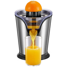 Stainless steel citrus juicer with black cone and glass cup filled with yellow juice