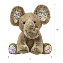 Gray plush elephant toy, full body view with colorful belly bib and floppy ears.