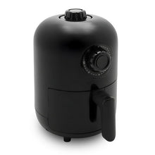 Compact black air fryer with top dial and side cooking basket handle.